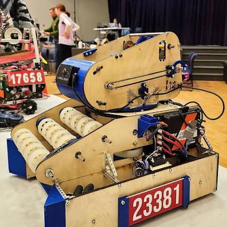 Plywood robot with blue end covers, mounting brackets, and chassis corner parts highlighted